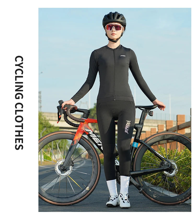 KiKis women's long sleeve cycling jersey in black worn by cyclist standing with road bike