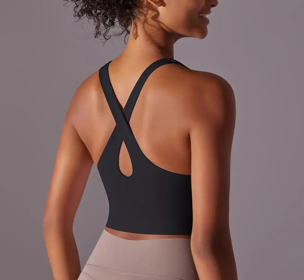 KiKis seamless crossback sports bra for women in black shown from the back on a model