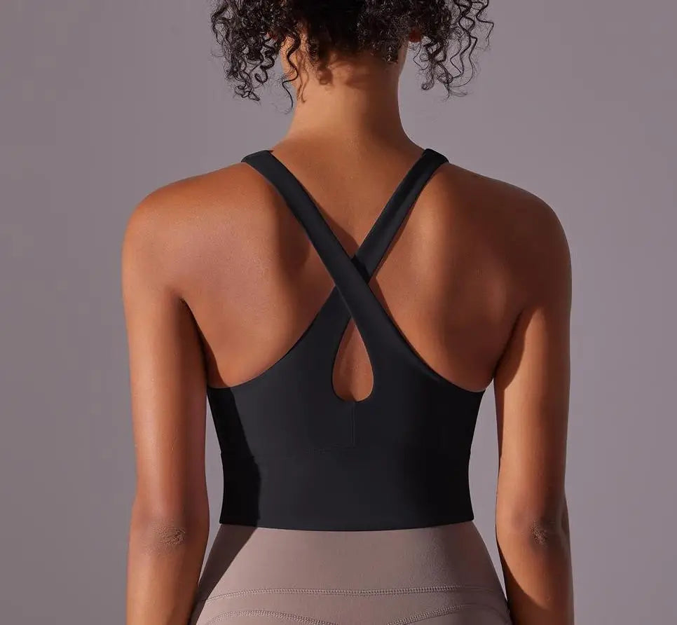 KiKis seamless crossback sports bra for women in black shown from the back with crossed straps
