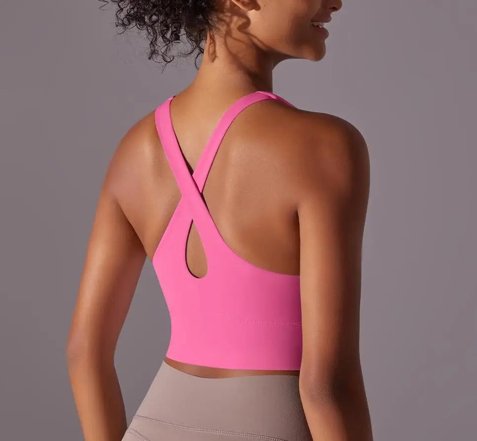 KiKis seamless crossback sports bra for women in pink shown from the back with crisscross straps