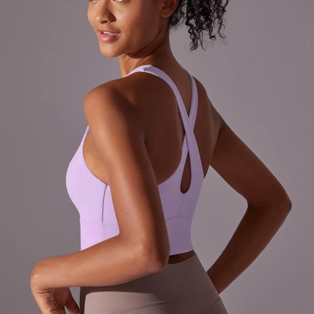 KiKis seamless crossback sports bra for women in light purple shown on model from the back