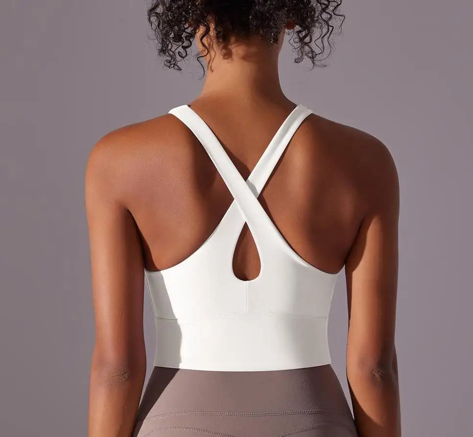 KiKis seamless crossback sports bra for women in white with supportive crisscross straps and keyhole back design