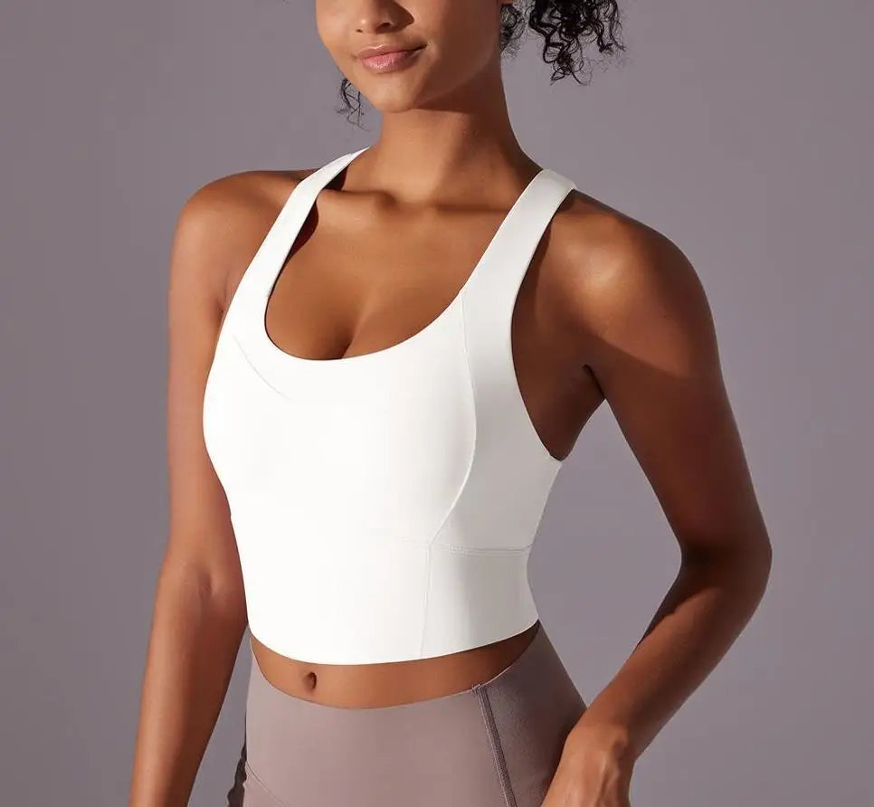 KiKis seamless crossback sports bra for women in white modeled on woman with fitted design