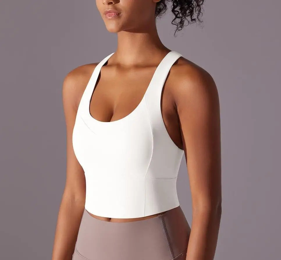 Seamless crossback sports bra for women in white worn by model with fitted design