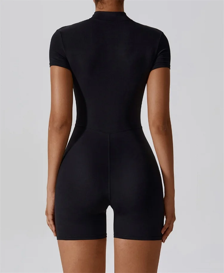 Back view of black short sleeve jumpsuit by KiKis, not a nude one-piece yoga jumpsuit