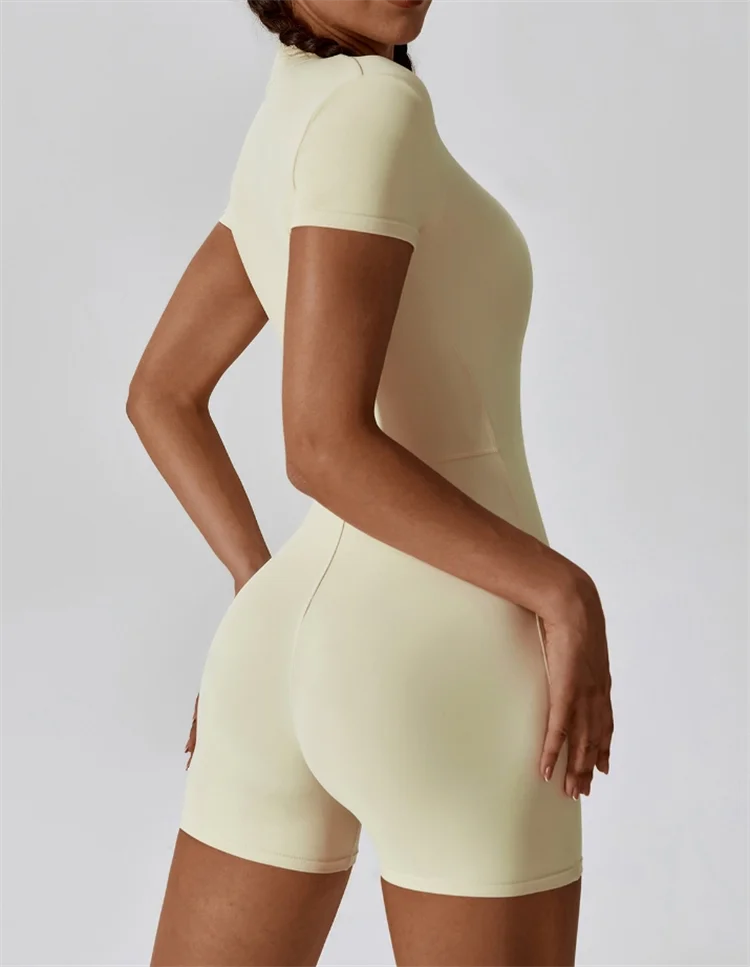 KiKis nude one-piece yoga jumpsuit with short sleeves and fitted design for active wear