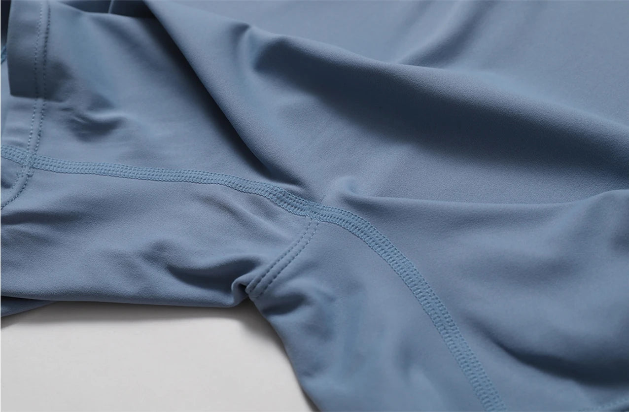 Close-up of nude one-piece yoga jumpsuit fabric and stitching details by KiKis