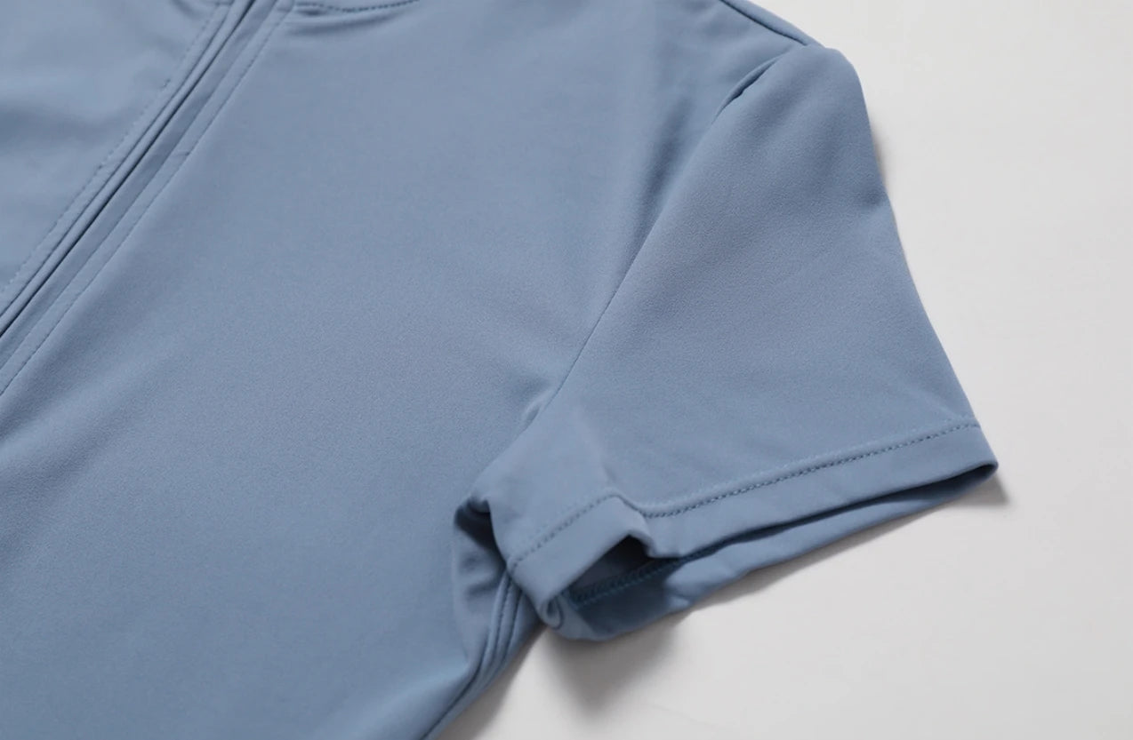 Close-up of sleeve and fabric detail of nude one-piece yoga jumpsuit by KiKis in blue tone