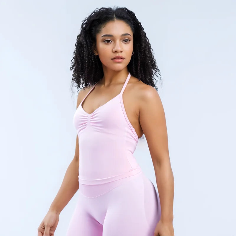 KiKis open back yoga tank top for women in light pink with ruched front detail worn by a model
