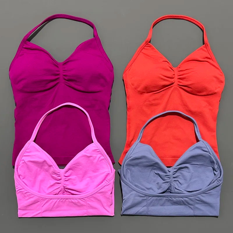 KiKis open back yoga tank top for women in pink, purple, red, and gray colors laid flat