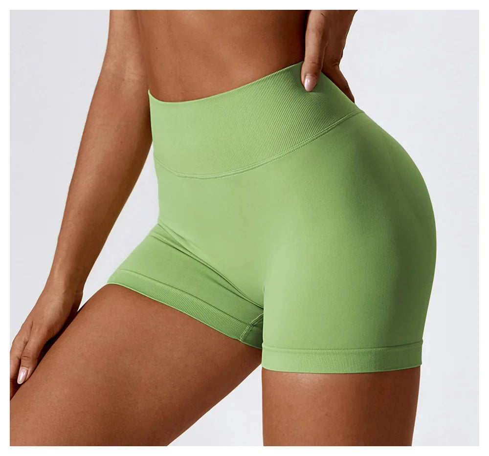 KiKis seamless scrunch butt gym shorts in light green on a fit woman with high waistband