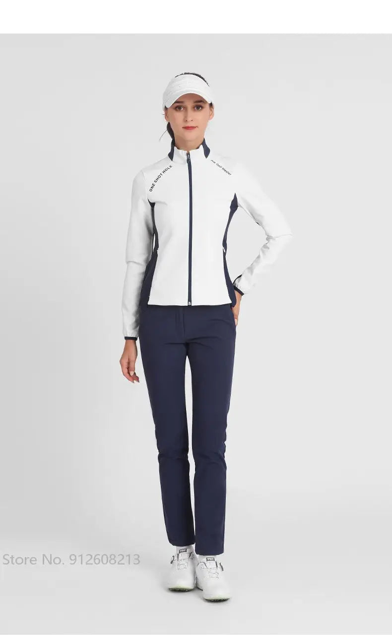 KiKis women's golf windbreaker jacket in white with black accents worn with navy pants and white golf shoes