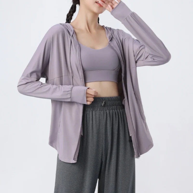 KiKis lavender lightweight zip-up hoodie worn over matching sports bra and gray sweatpants