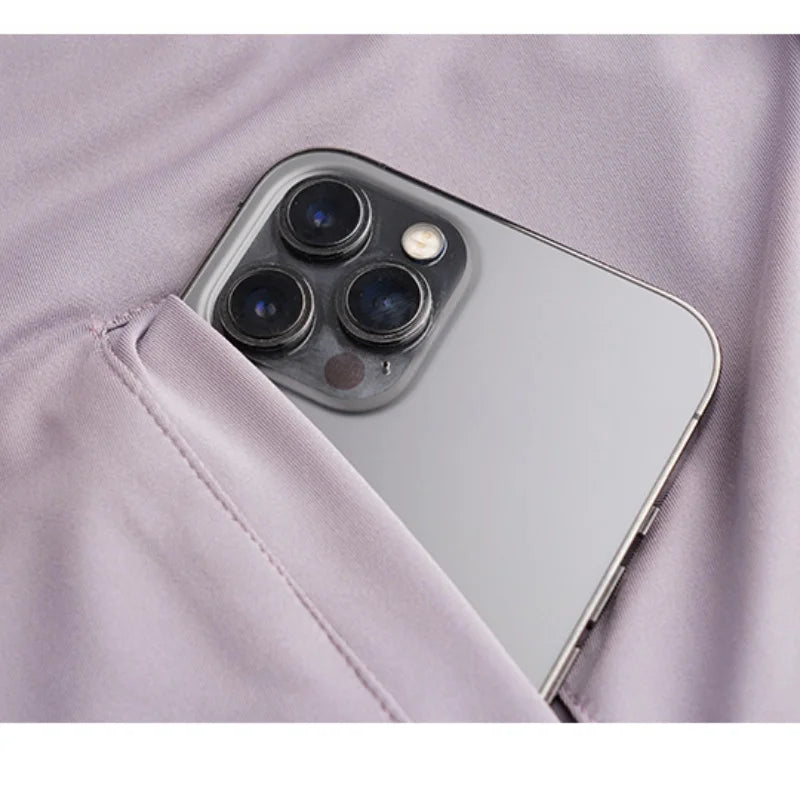 Silver smartphone with triple-camera partially tucked into lavender fabric pocket by KiKis