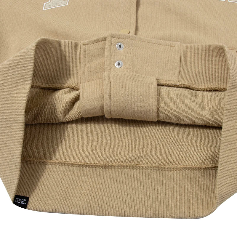 Close-up detail of beige women's Puma track jacket cuff and fabric texture by KiKis