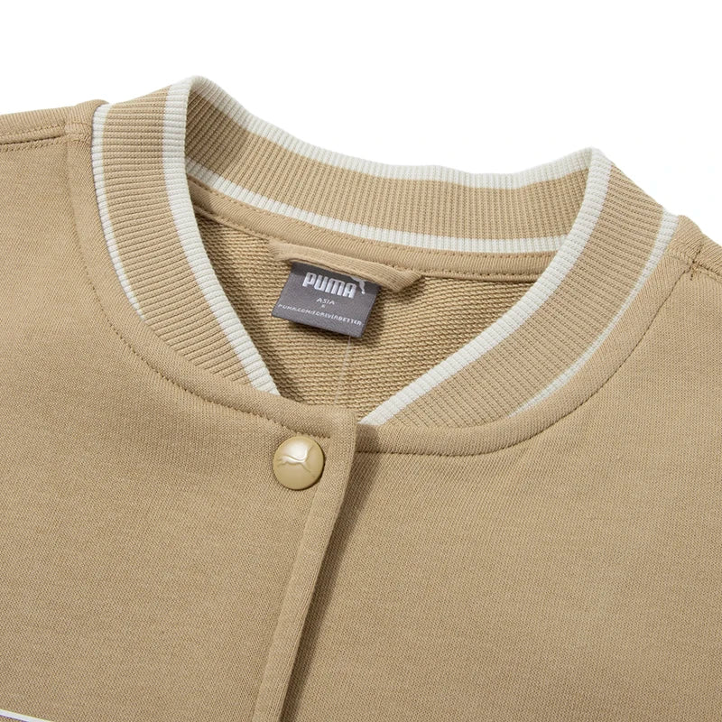 Close-up of beige women's Puma track jacket collar and button detail from KiKis