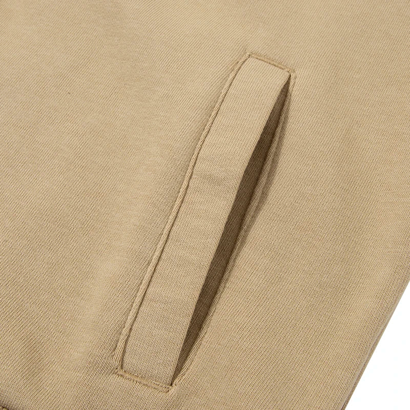 Close-up of beige fabric pocket detail on women's Puma track jacket by KiKis