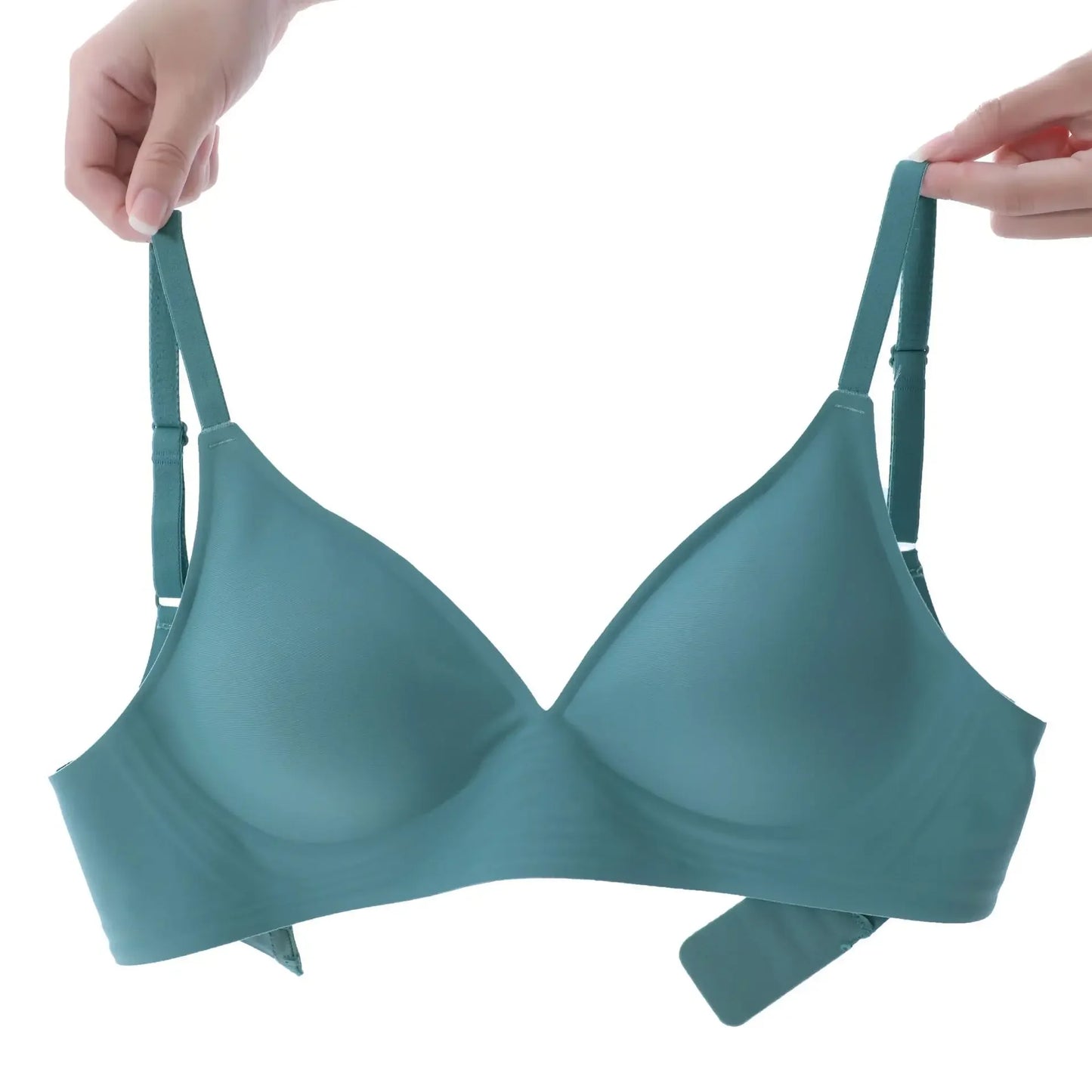 KiKis seamless push up bra for women in teal held by two hands showing adjustable straps