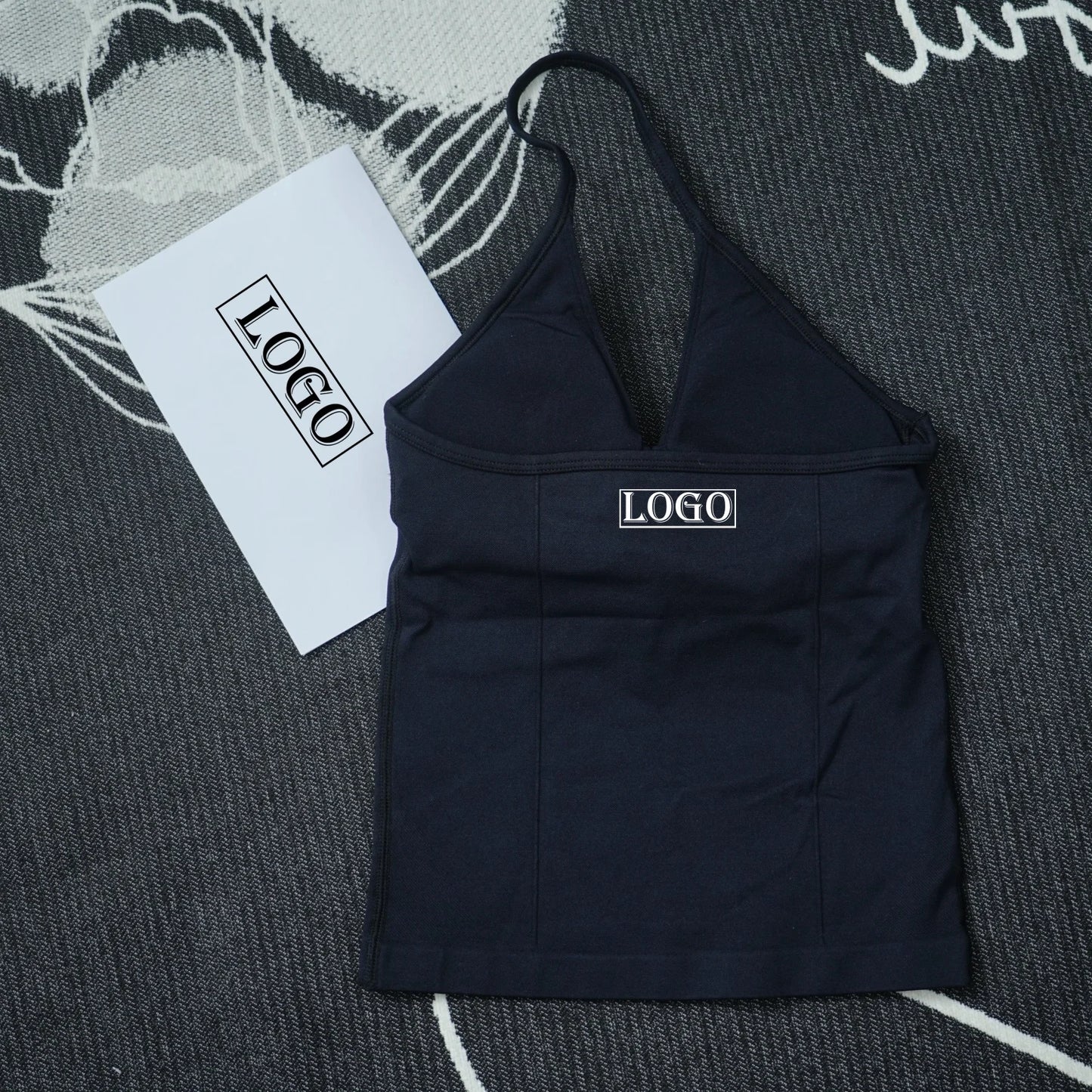 KiKis black seamless yoga sports bra with thin straps and logo on front