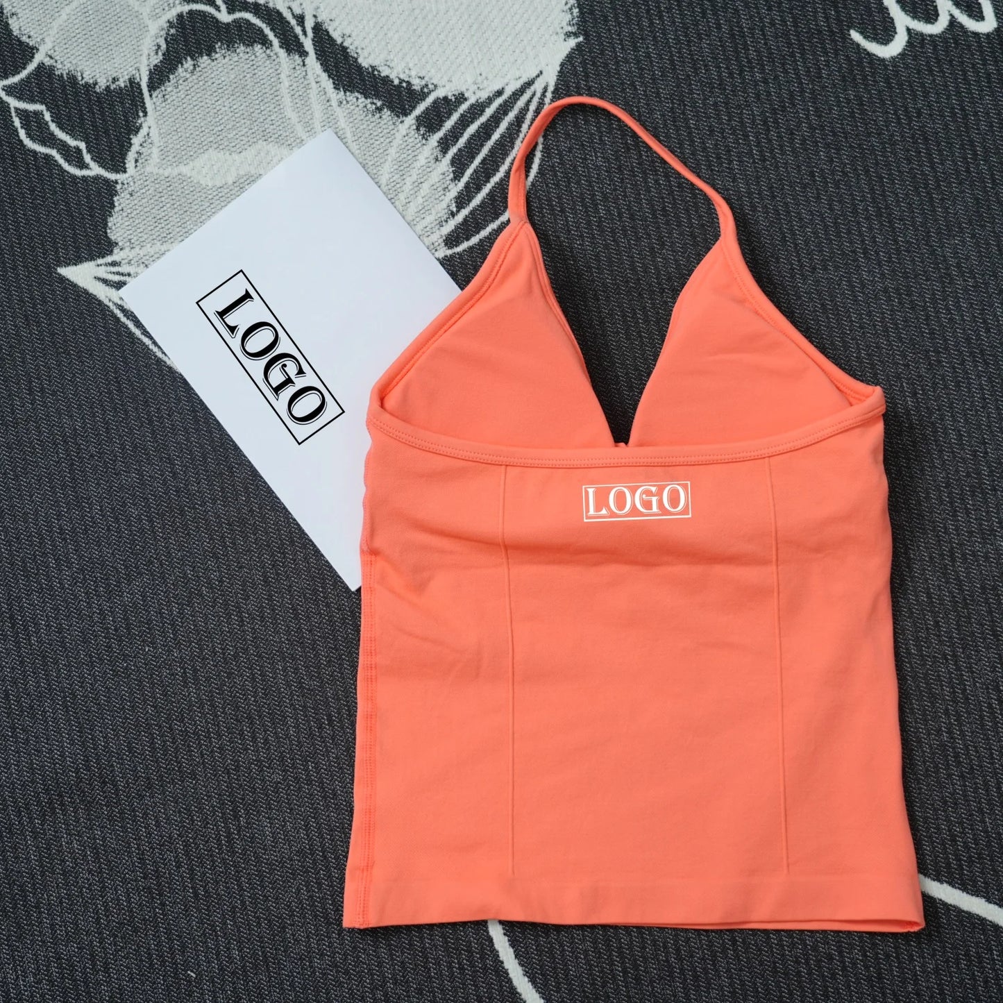 KiKis seamless yoga sports bra in coral color with thin straps and logo on front