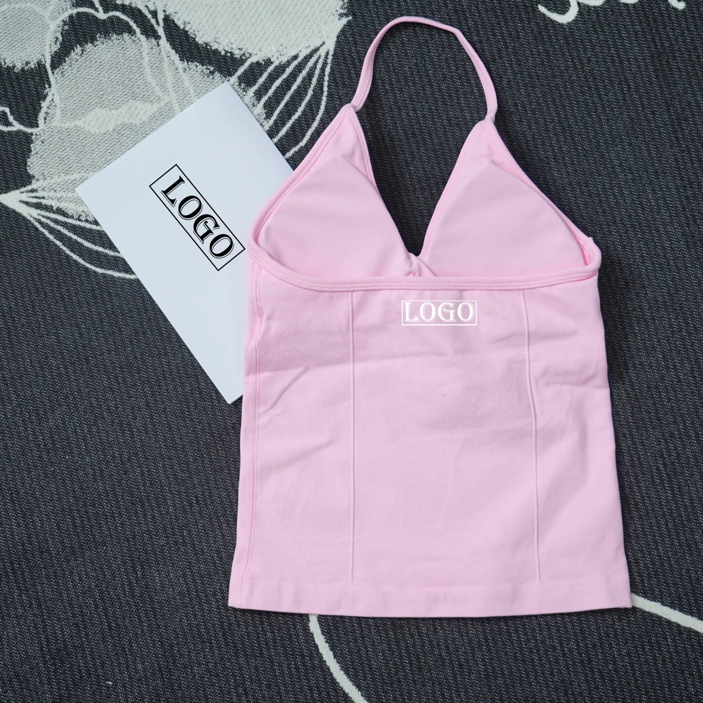 KiKis pink seamless yoga sports bra with thin straps and supportive design on dark textured background