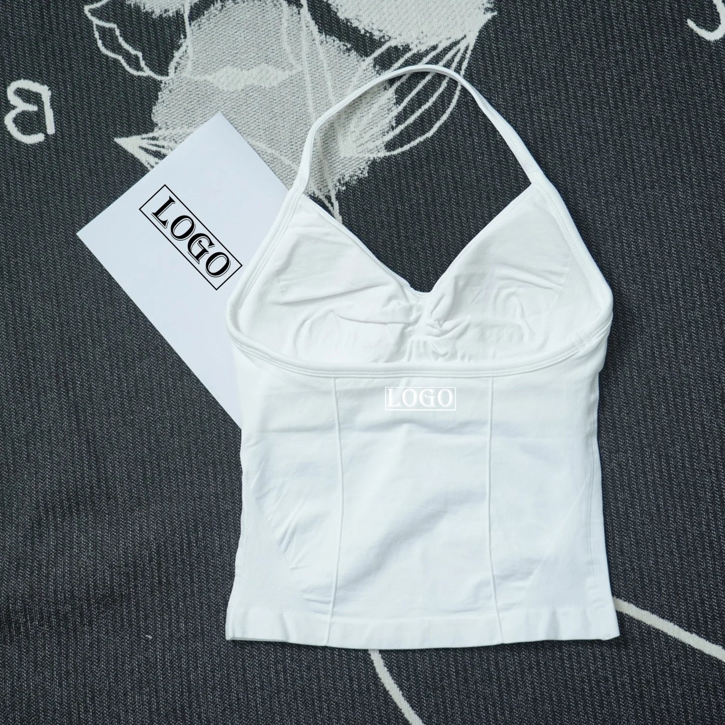 White seamless yoga sports bra with thin straps and ruched bust design from KiKis
