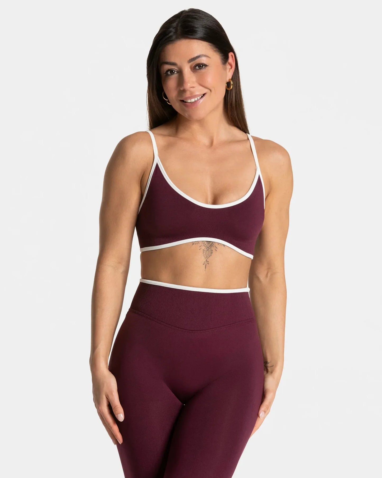 KiKis shockproof yoga bra outdoor fitness in burgundy with white trim worn by woman