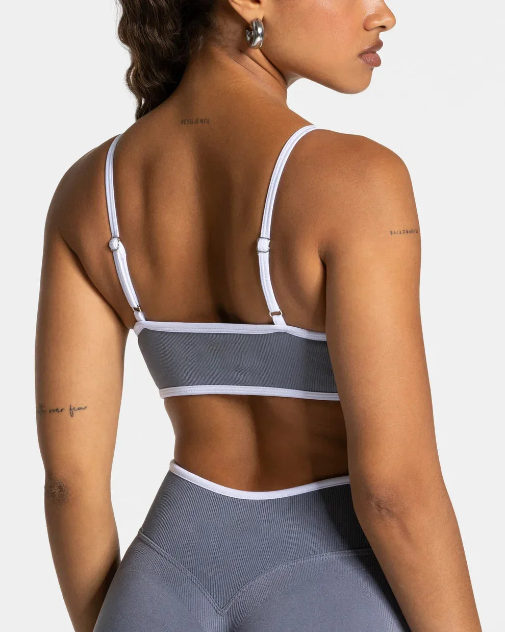 KiKis shockproof yoga bra outdoor fitness with adjustable straps in gray and white worn by a woman
