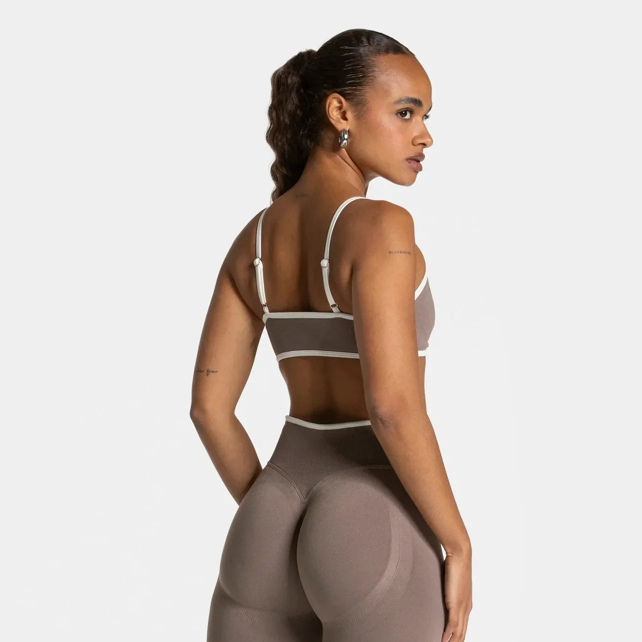KiKis shockproof yoga bra outdoor fitness worn by woman showing back and adjustable straps in taupe color