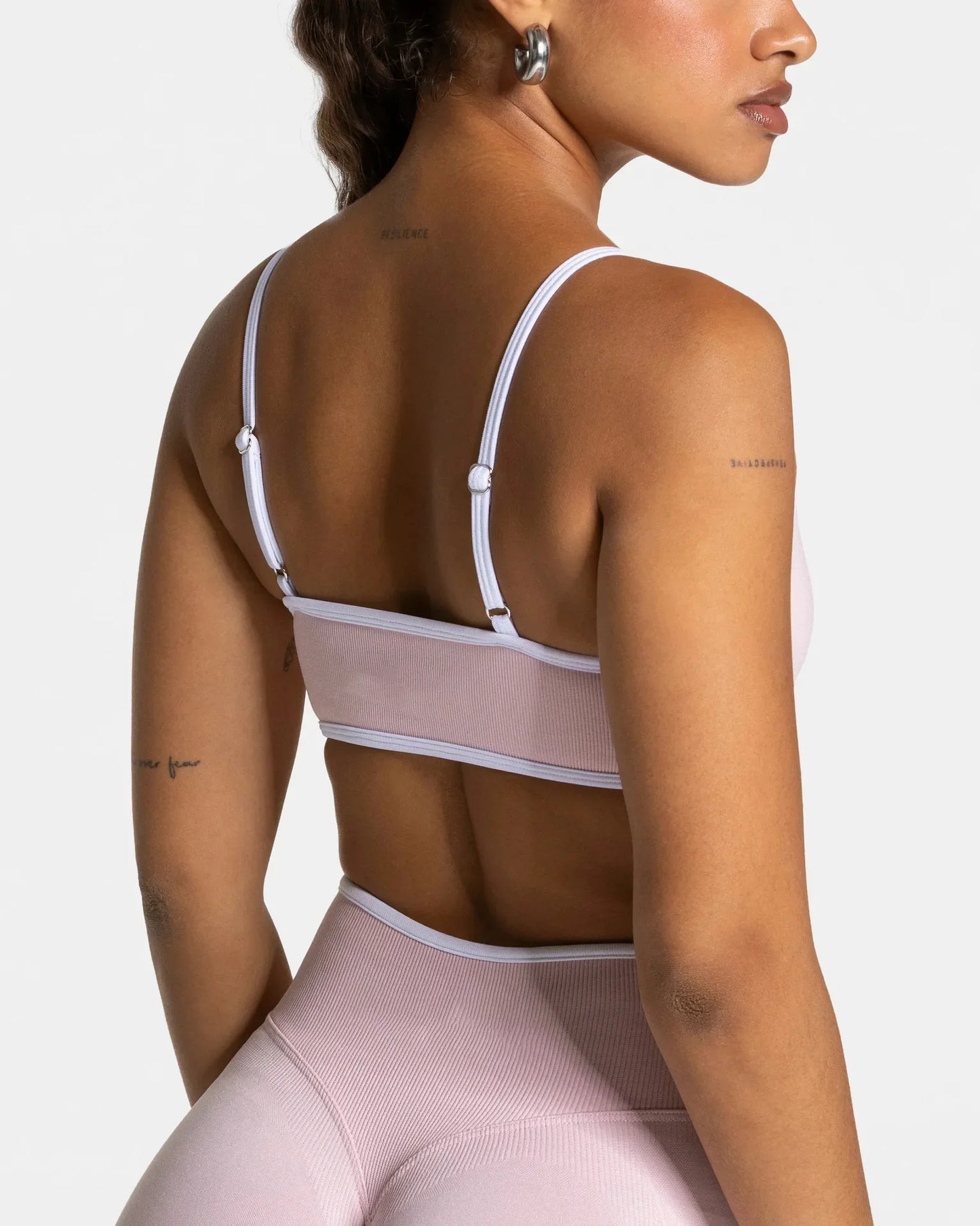 KiKis shockproof yoga bra outdoor fitness in light pink worn by a woman shown from the back