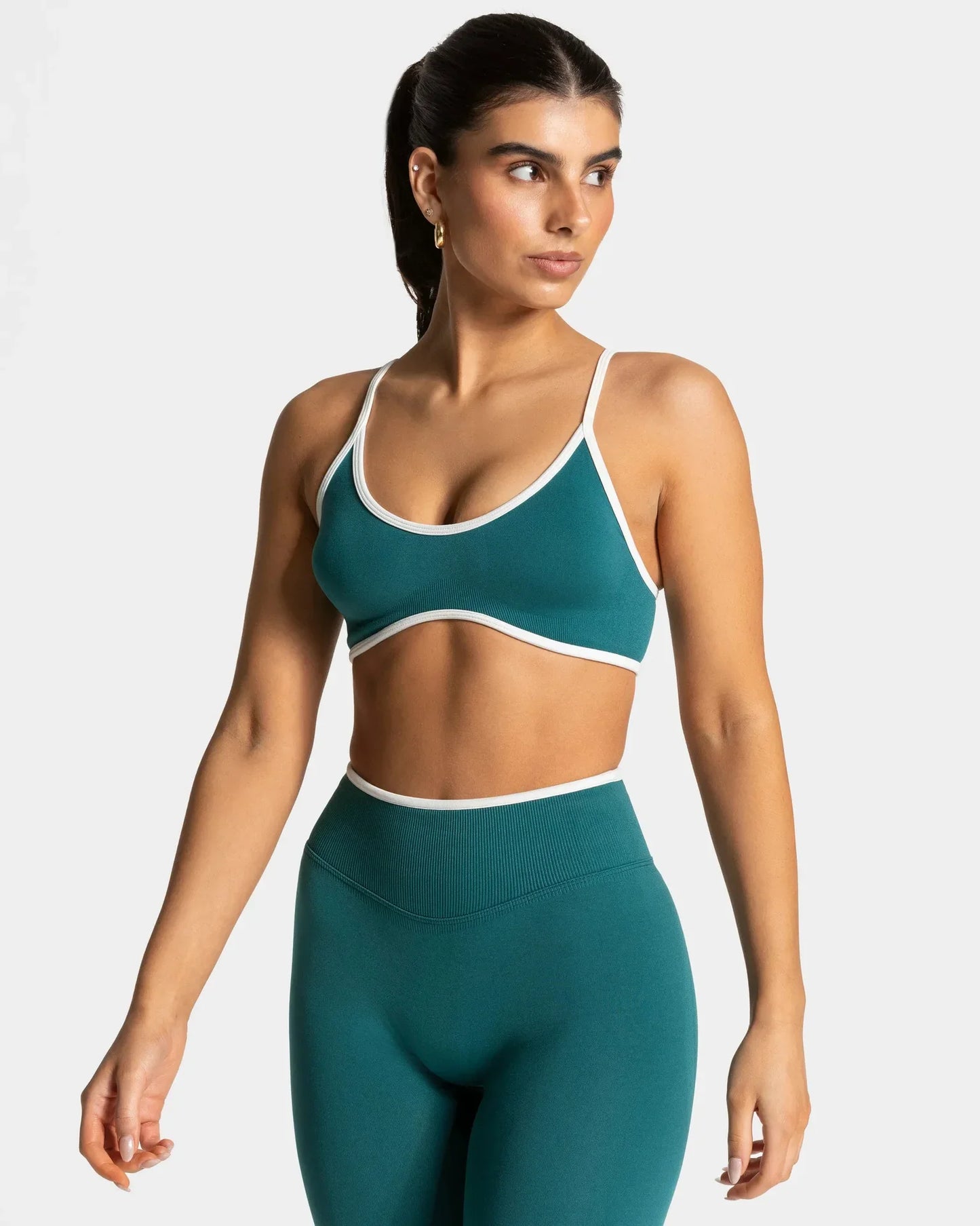 KiKis shockproof yoga bra outdoor fitness in teal with white trim modeled for activewear