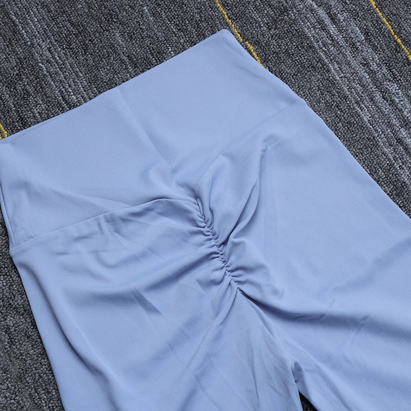 Light blue Womens Seamless Yoga pants by SOISOU with ruched detail on gray carpet background