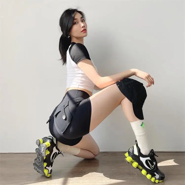 Woman wearing KiKis high waisted cycling shorts women in black with pockets and sporty shoes