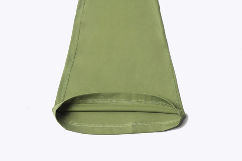 Close-up of green Womens Bell bottom yoga pants leg showing fabric texture and stitching detail