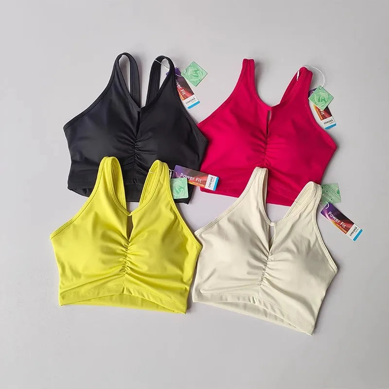 KiKis women's push up sports bra in black, pink, yellow, and white colors with ruched front design