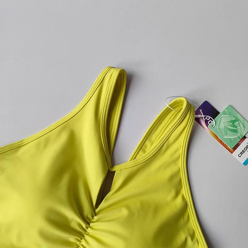 KiKis women's push up sports bra in bright yellow with a keyhole front design