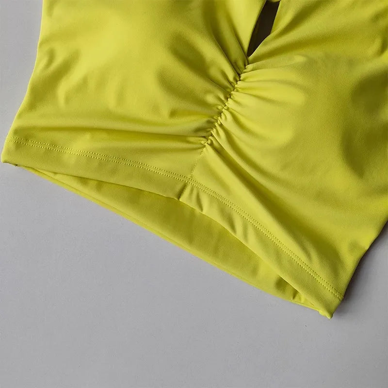 KiKis bright yellow women's push up sports bra with ruched front detail close-up