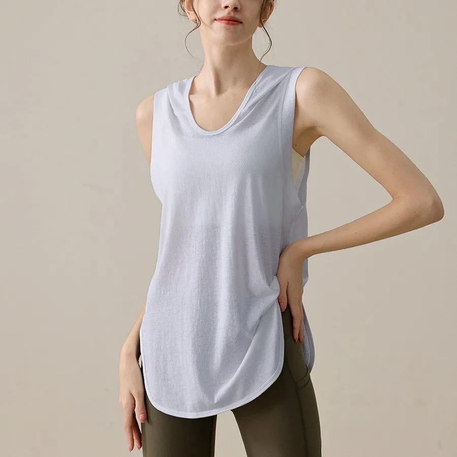 KiKis lightweight summer sleeveless workout hoodie in light gray worn with olive leggings
