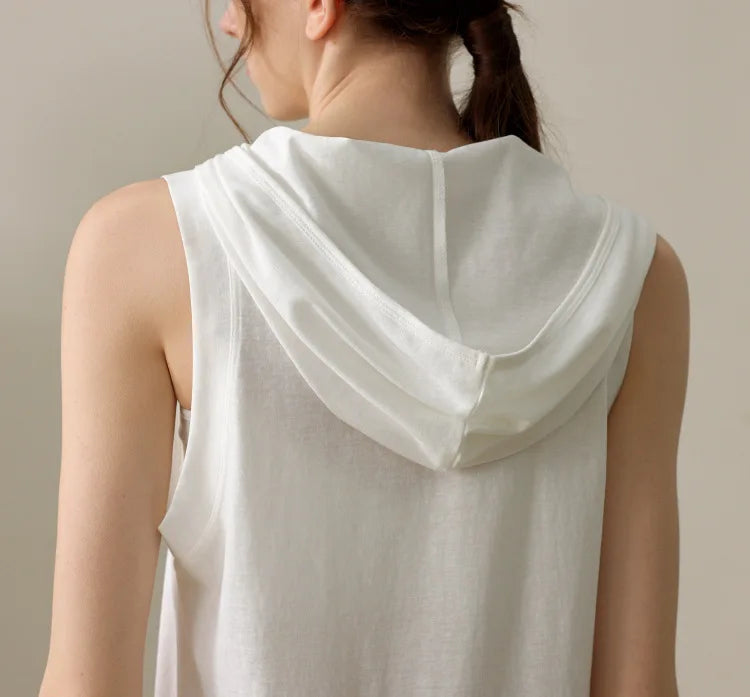Back view of white summer sleeveless workout hoodie by KiKis on a woman with tied hair