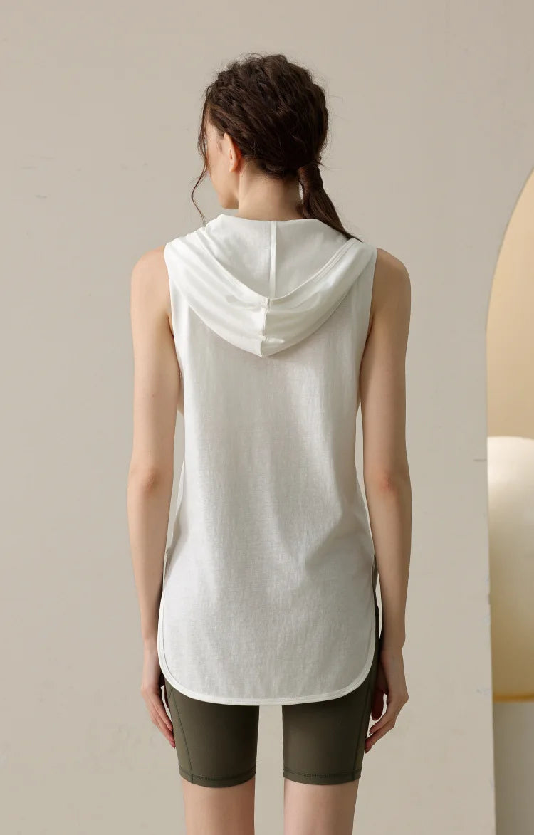 KiKis white summer sleeveless workout hoodie worn by woman shown from back with hood down