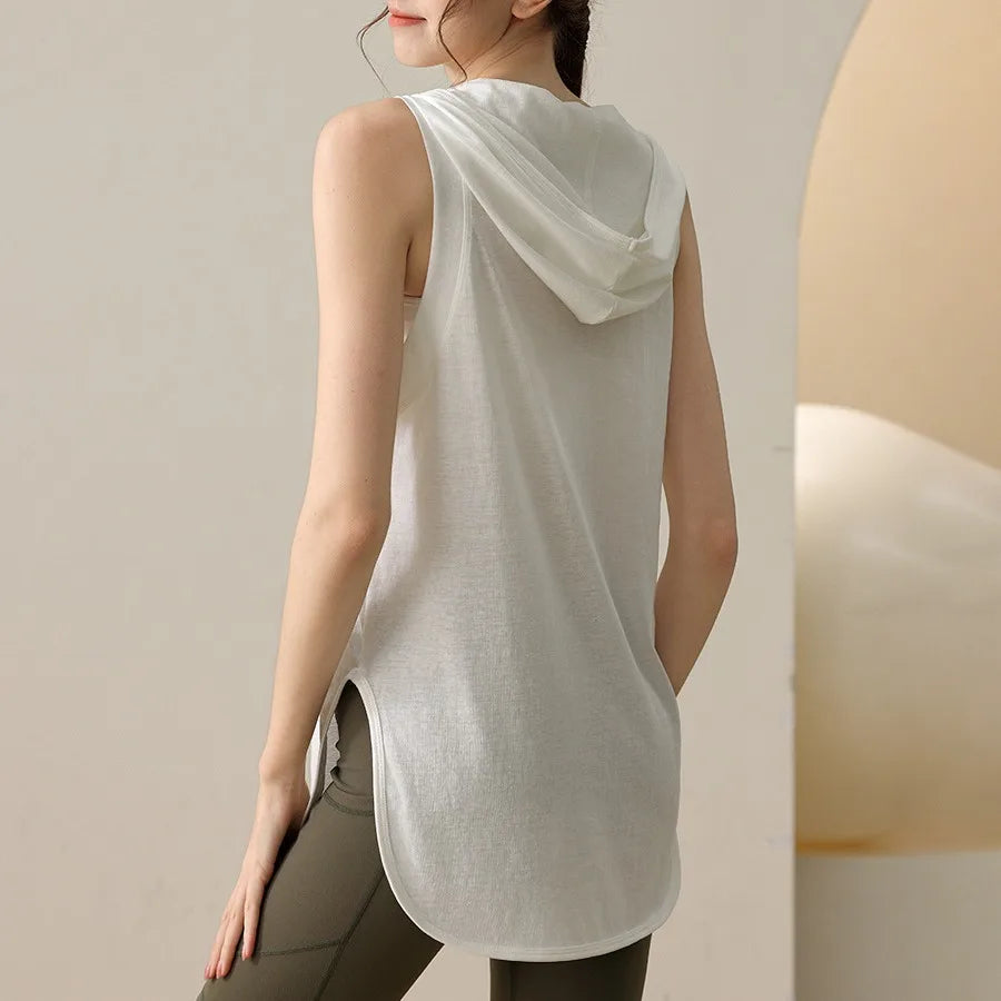 KiKis white summer sleeveless workout hoodie with hood and curved hem worn by woman from back