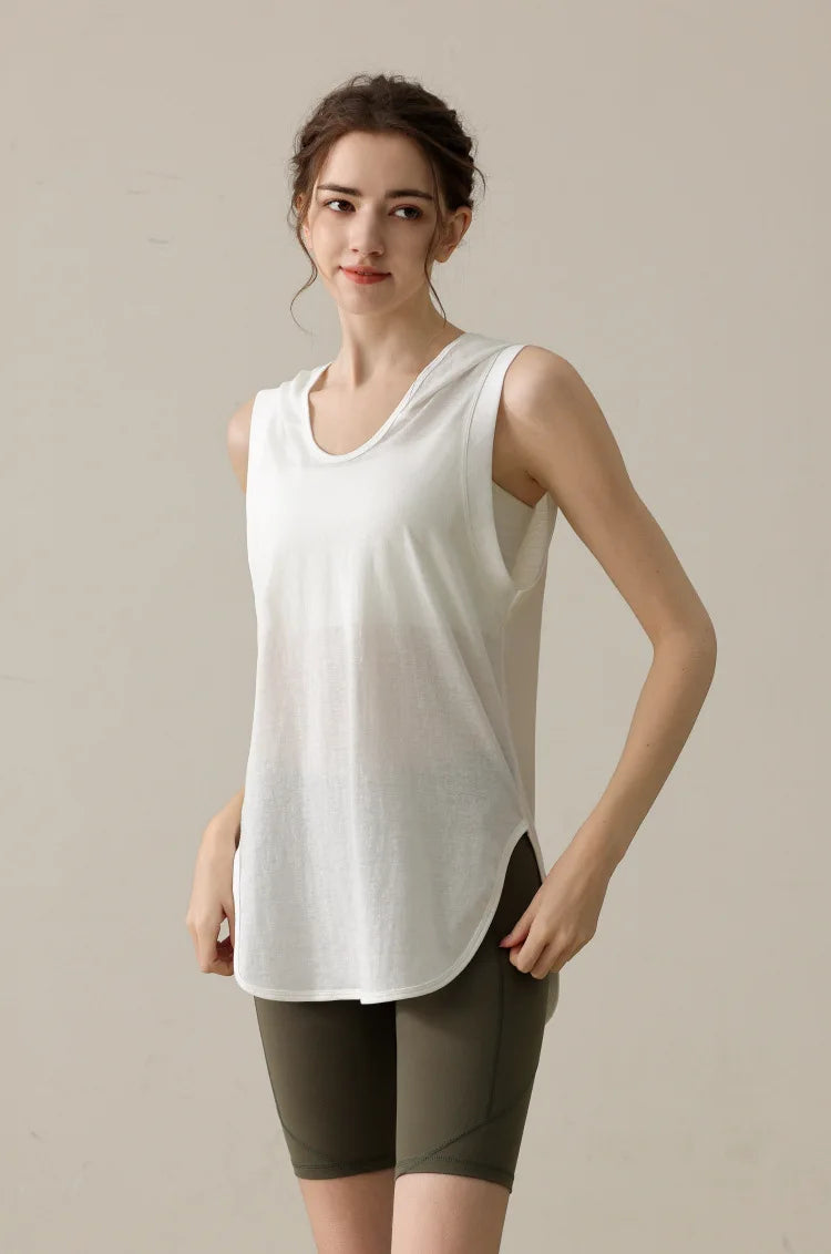 KiKis white summer sleeveless workout hoodie worn by woman with olive green shorts