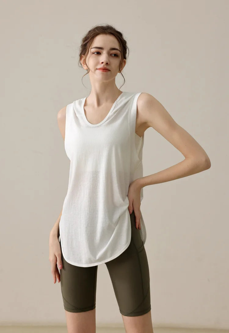 KiKis summer sleeveless workout hoodie in white worn with olive green shorts for activewear