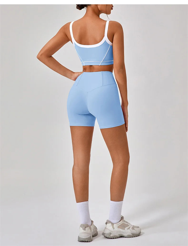 Back view of a woman wearing women's nude fitness shorts set styled with a blue sports bra and white sneakers