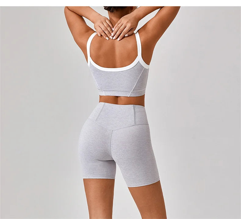 Back view of woman wearing women's nude fitness shorts set in light gray with white trim by KiKis