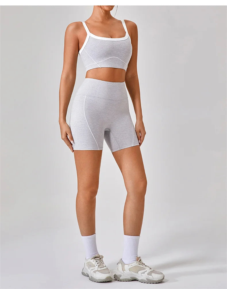 KiKis women's nude fitness shorts set modeled with matching crop top and sneakers