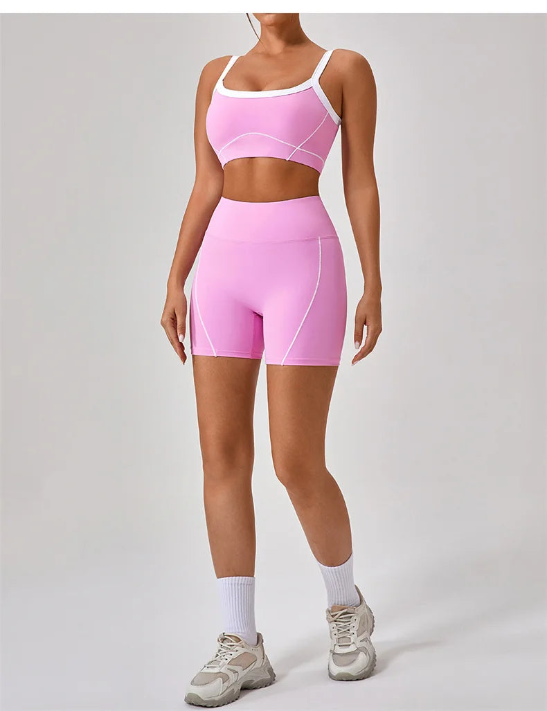KiKis women's nude fitness shorts set in pink with white trim worn with white socks and sneakers