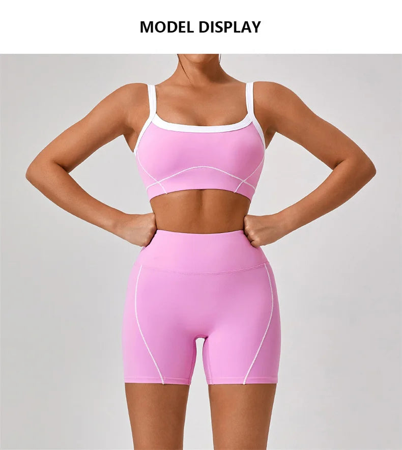 KiKis women's nude fitness shorts set in pink with white trim modeled on a fit woman