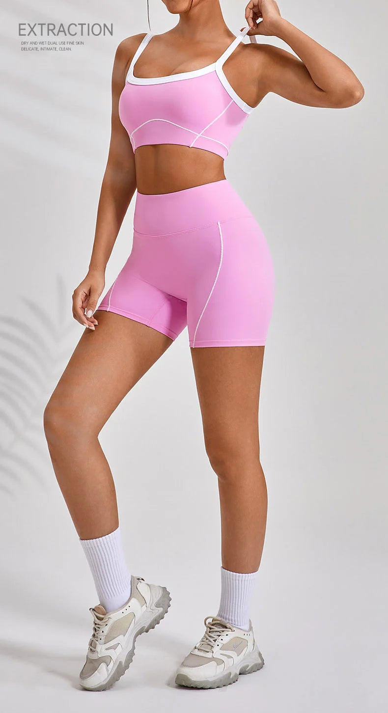 KiKis women's nude fitness shorts set in pink with white trim worn with matching sports bra and sneakers