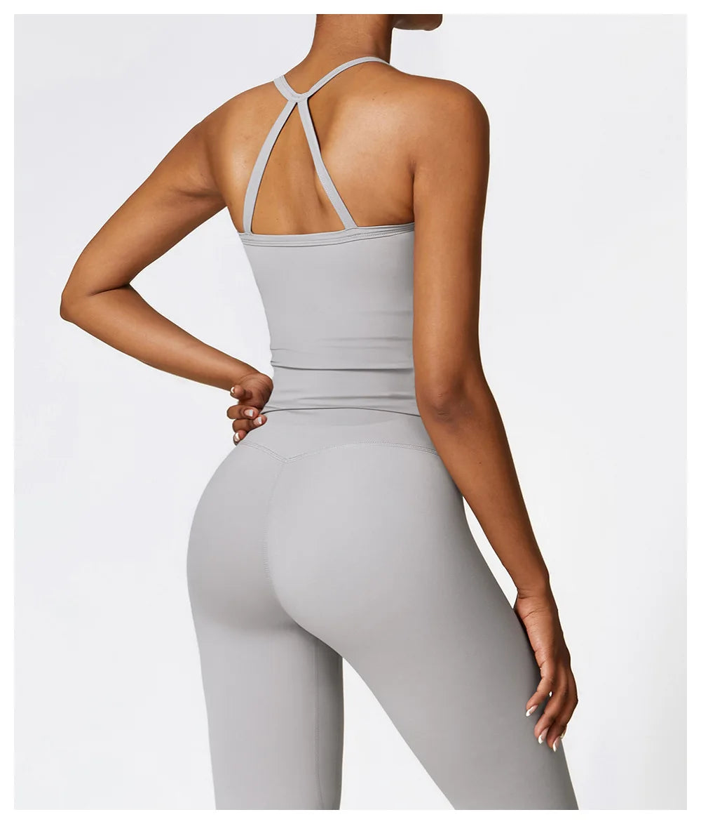 Back view of a woman wearing KiKis breathable gym workout bra for women in light gray with thin straps